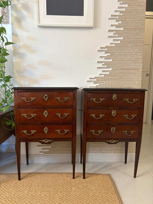 Pair of vintage French Louis XIV bedside tables with ornate brass handles and carved details in antique finish