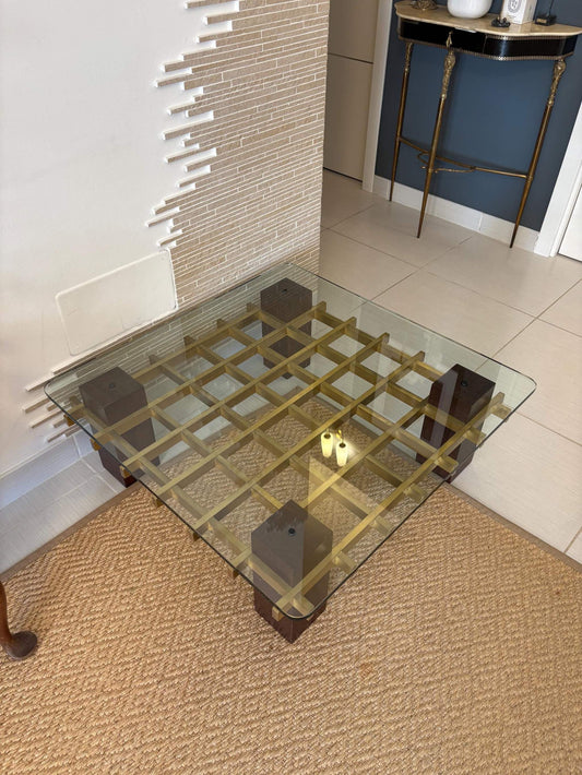 Vintage living room coffee table with brass grid and wooden cube legs under tempered glass top in Italian mid-century modern style